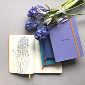 Produktfoto von Rhodia Notebook A5 Softcover in der Farbe schwertlilieviolett / product photo of Rhodia Notebook A5 Softcover in the colour iris butterfly violet (RH_117459C)